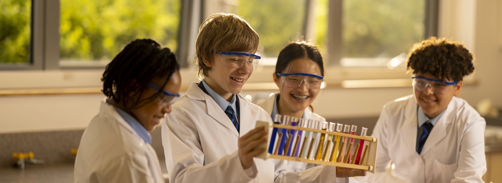 Senior pupils wearing lab safety gear in doing experiment at Ibstock Place School, a private school near Richmond.