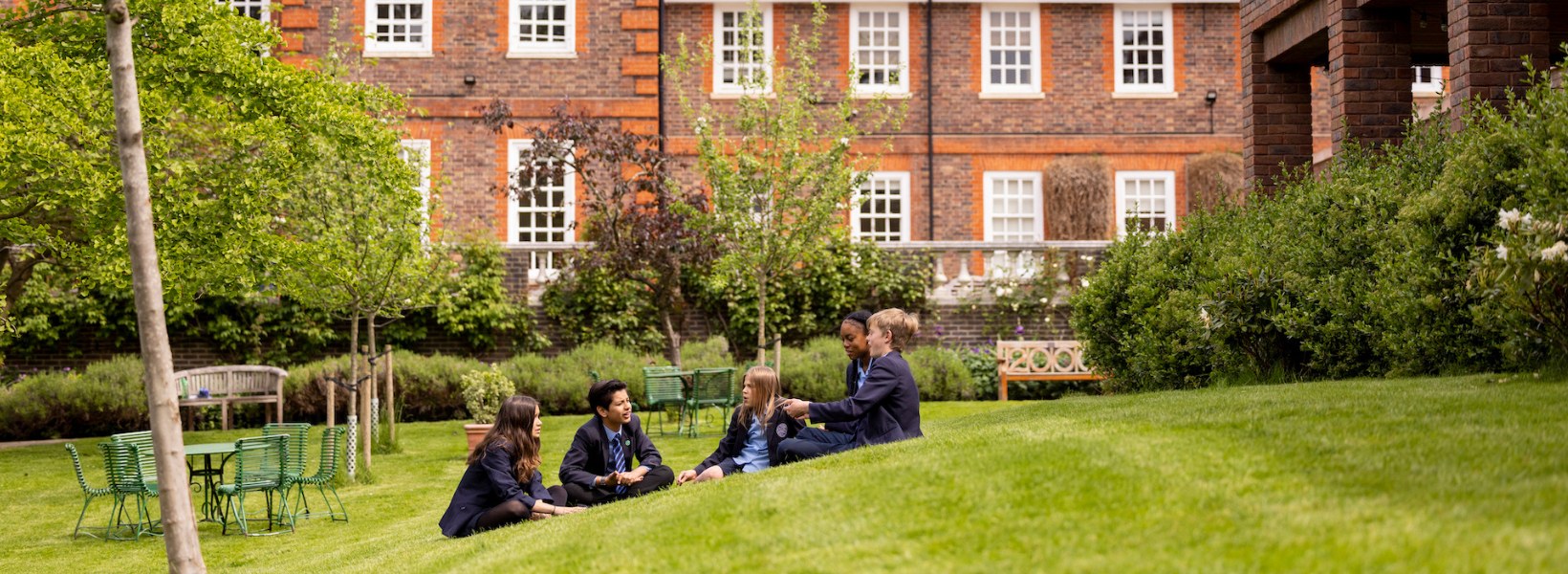 Pupils of Ibstock Place School sitting in the garden.