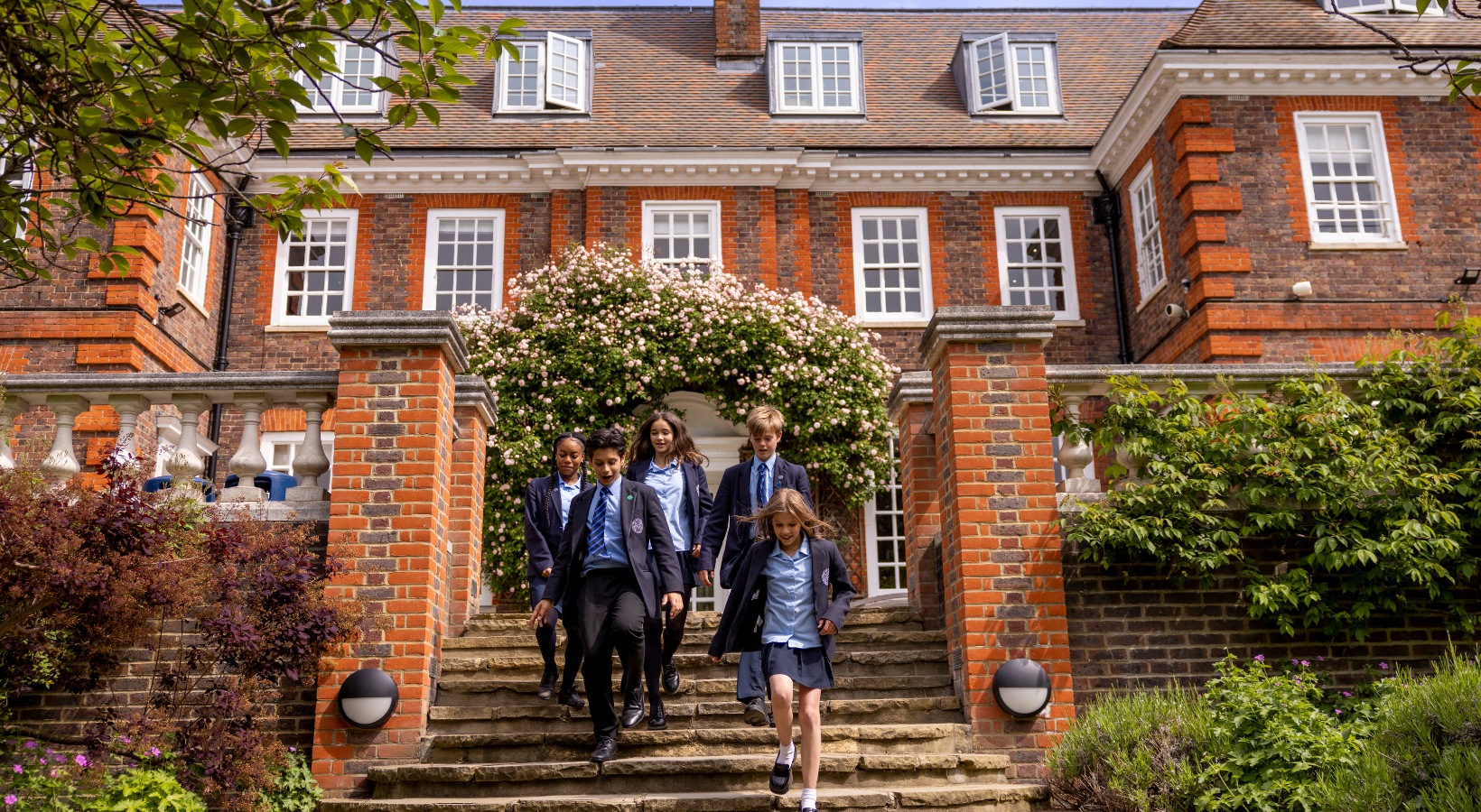 Pupils running down the main stairs of Ibstock Place School, Near Richmond, Barnes, Putney, Kingston, & Wandsworth 