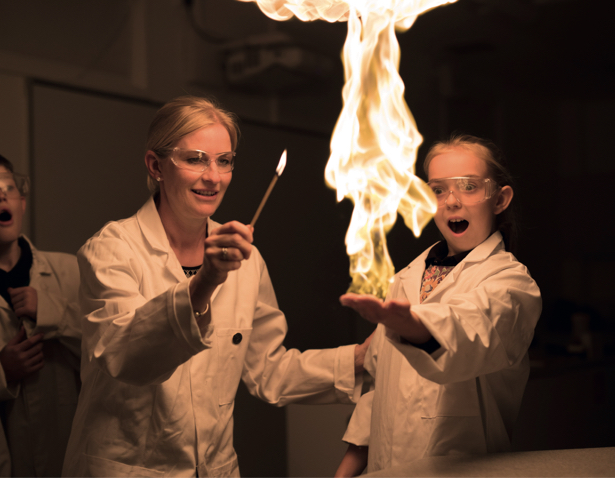 Prep pupil with their science teacher doing a science experiment in the lab of Ibstock Place School