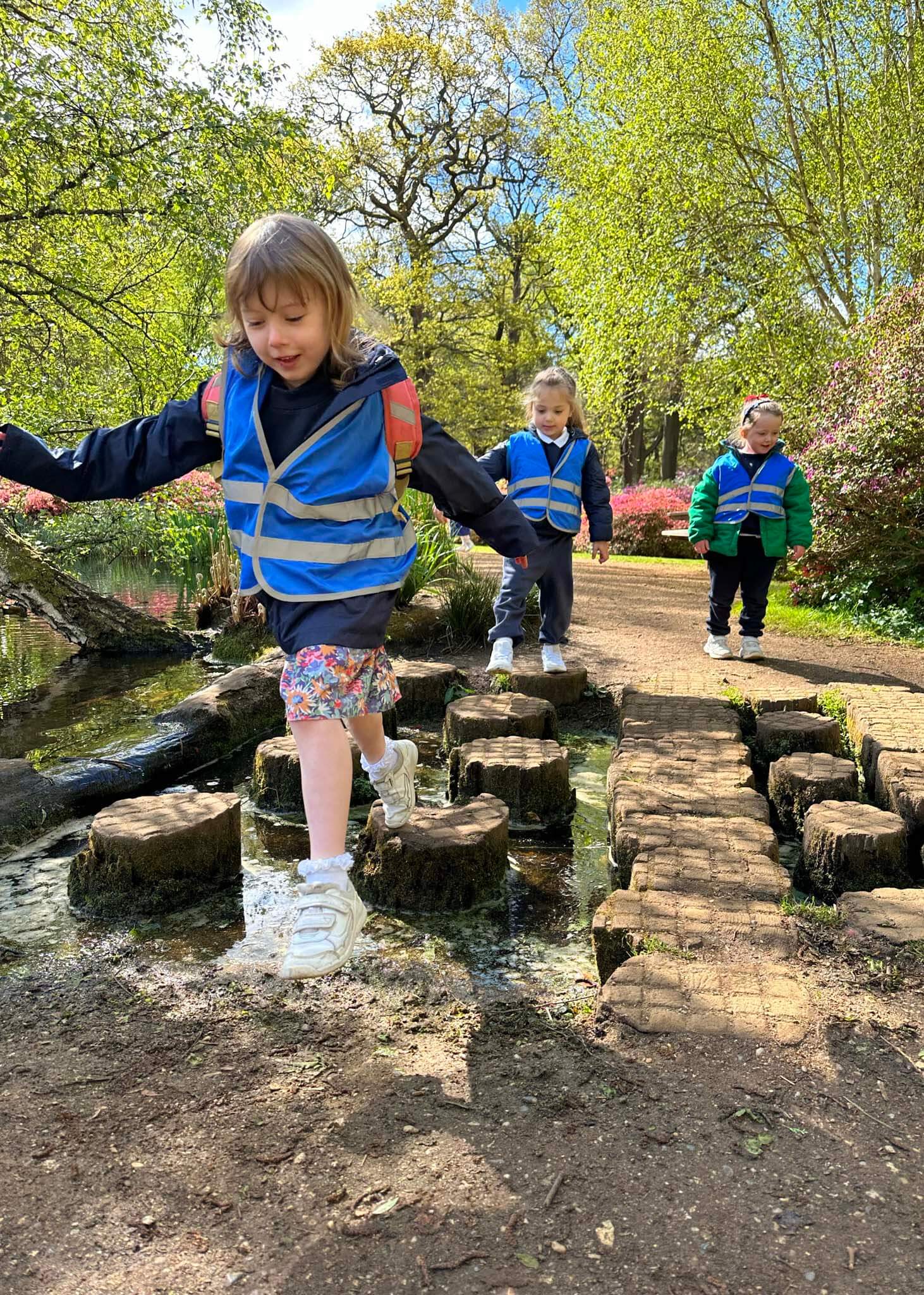 Kindergarten pupils on the stepping stones| Ibstock Place School, a private school near Richmond, Barnes, Putney, Kingston, and Wandsworth.