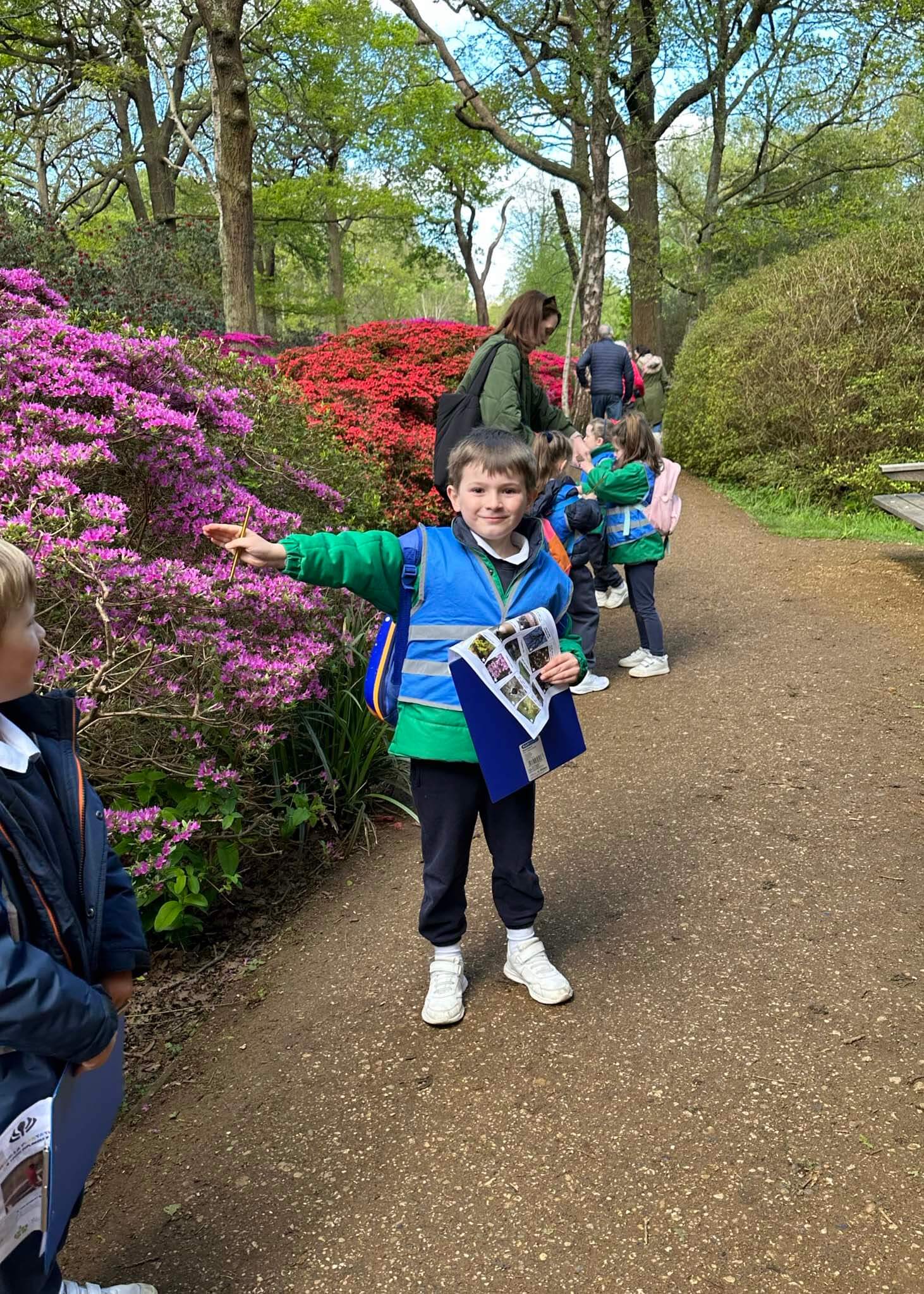 Kindergarten pupil pointing at the flowers | Ibstock Place School, a private school near Richmond, Barnes, Putney, Kingston, and Wandsworth.