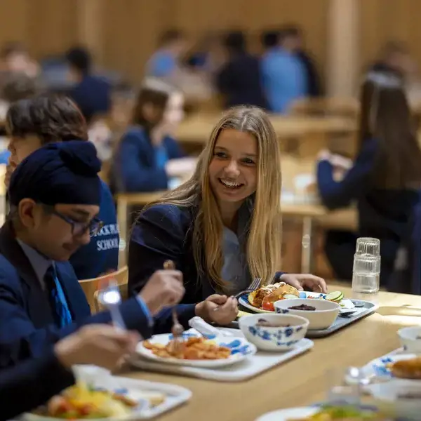 Senior pupils eating lunch in the Great Hall of Ibstock Place School.