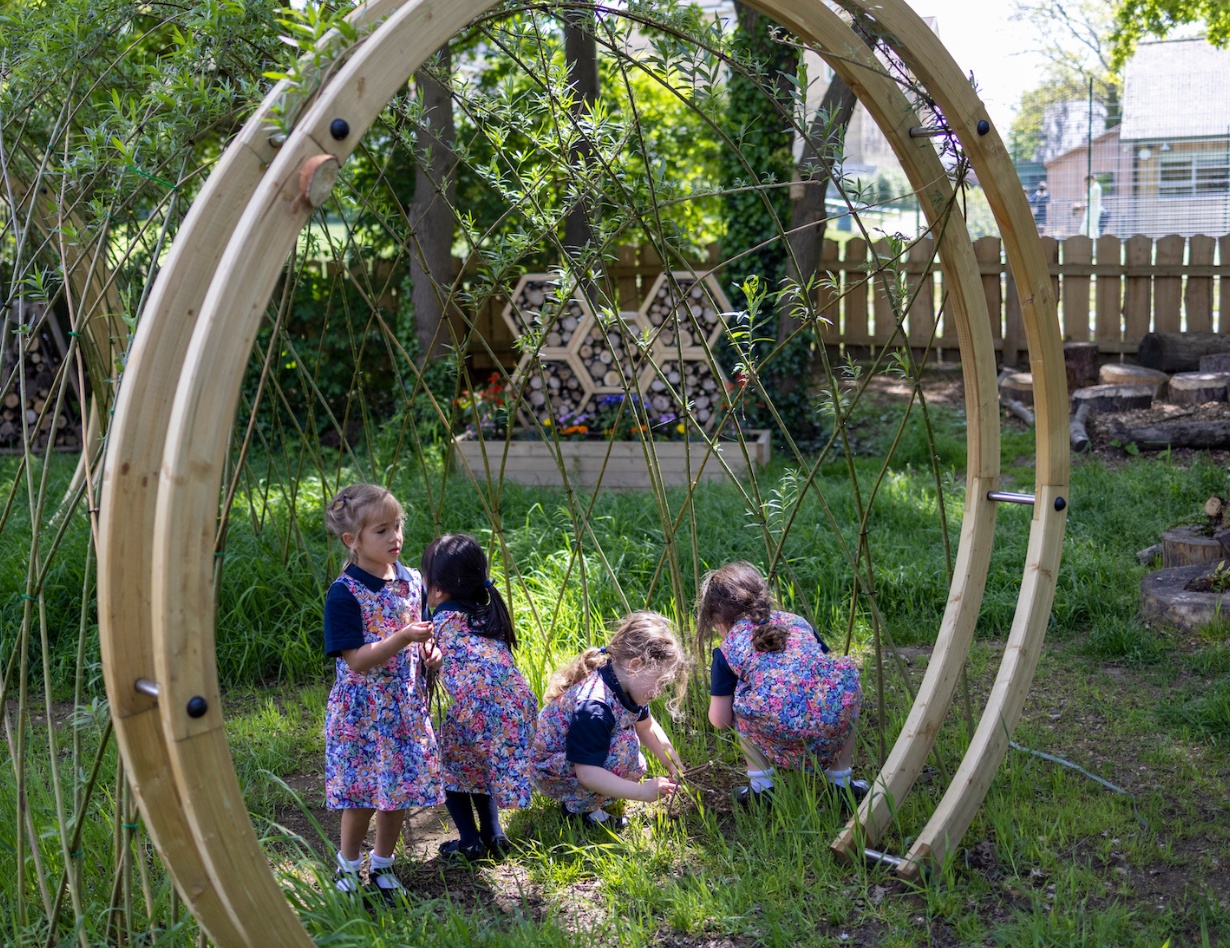 prep pupils playing in the forest school of Ibstock Place School, a private school near Richmond.