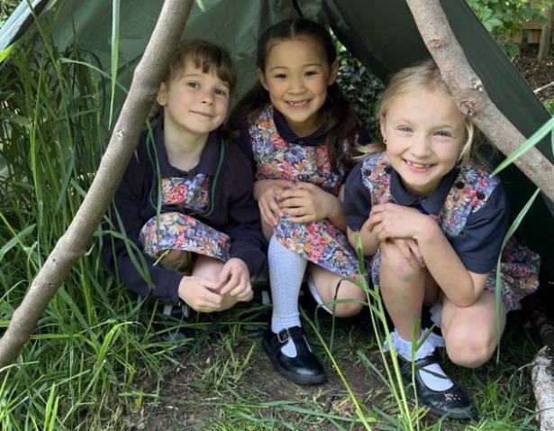 Pre-prep pupils playing in the forest school of Ibstock Place School, a private school near Richmond