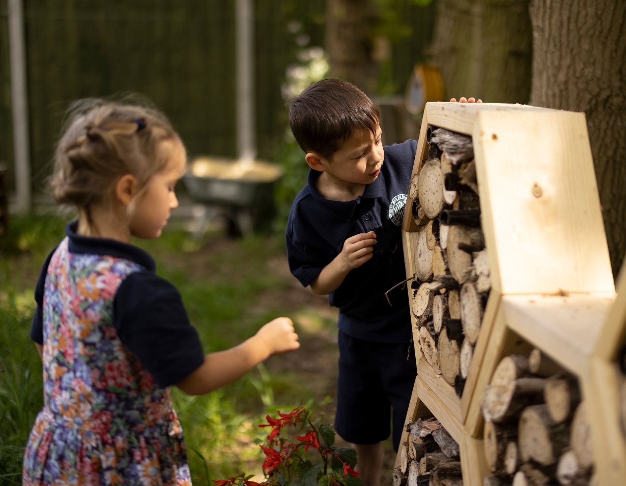 prep pupils playing in the forest school of Ibstock Place School, a private school near Richmond.