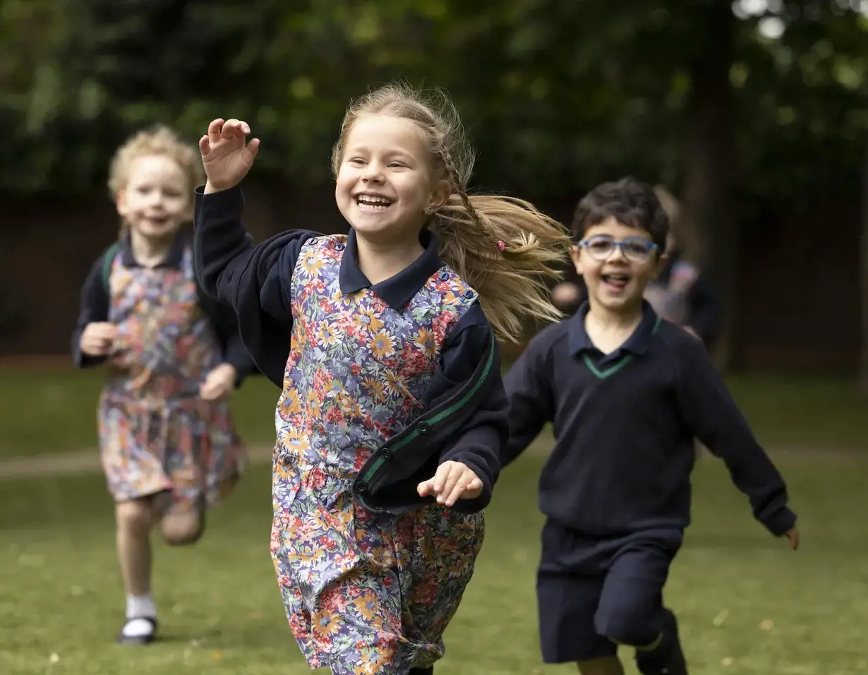 Prep pupils running in the playground and having fun at Ibstock Place School