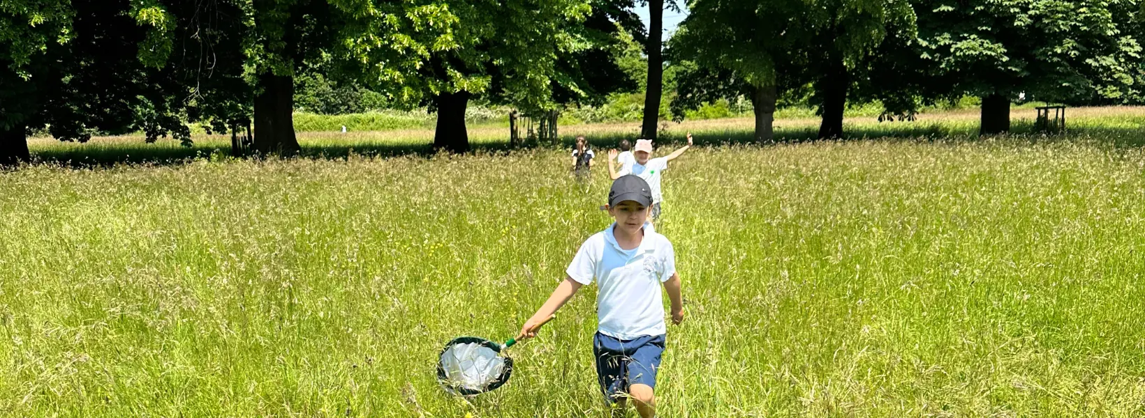 prep pupils running through the grounds of Richmond Park near Ibstock Place School.