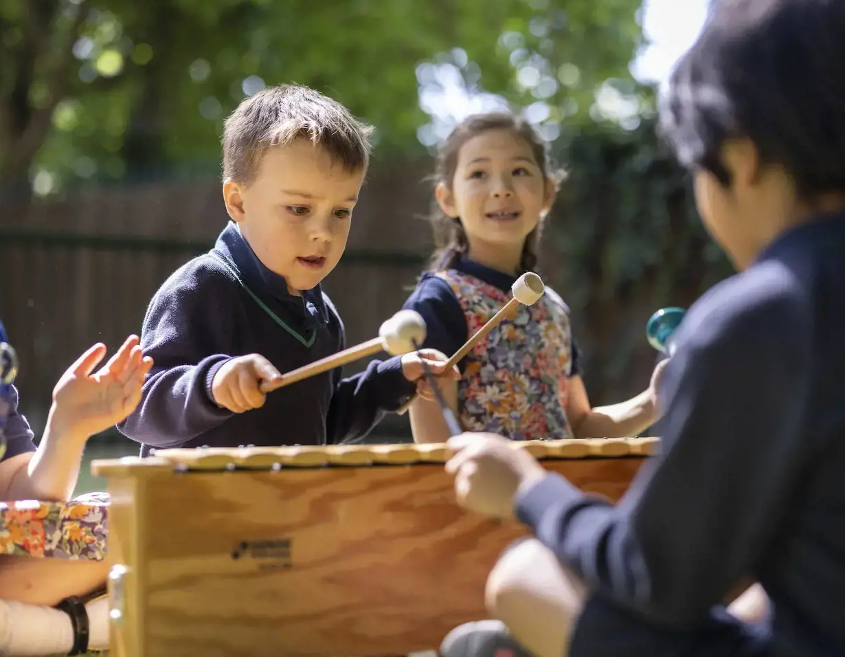 Pre-prep pupils learning music outside the classroom at Ibstock Place School, a private school near Richmond