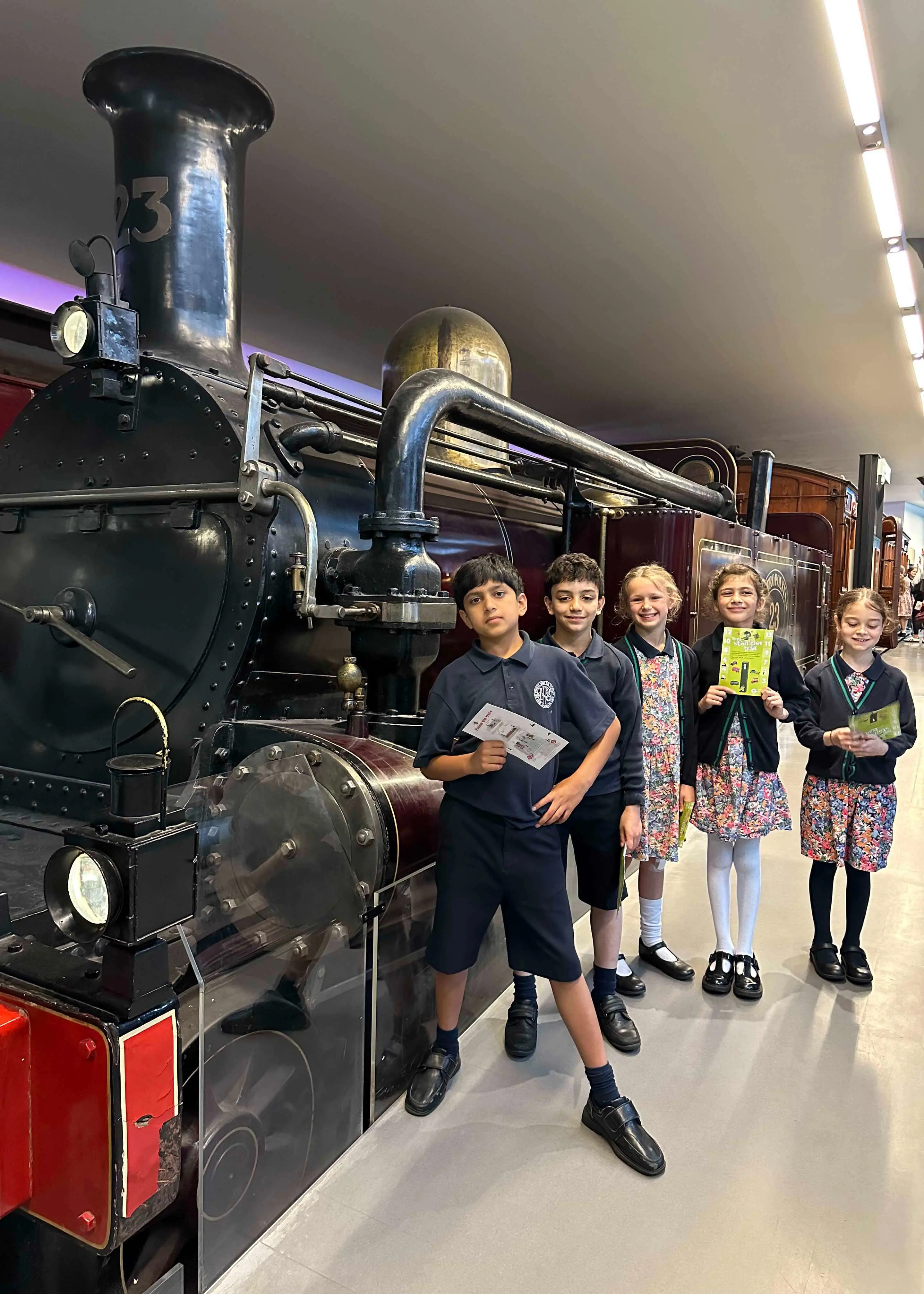 Prep 4 pupils at the London Transport Museum standing in front of steam engine | Ibstock Place School, a private school near Richmond, Barnes, Putney, Kingston, and Wandsworth on an overseas trip. 