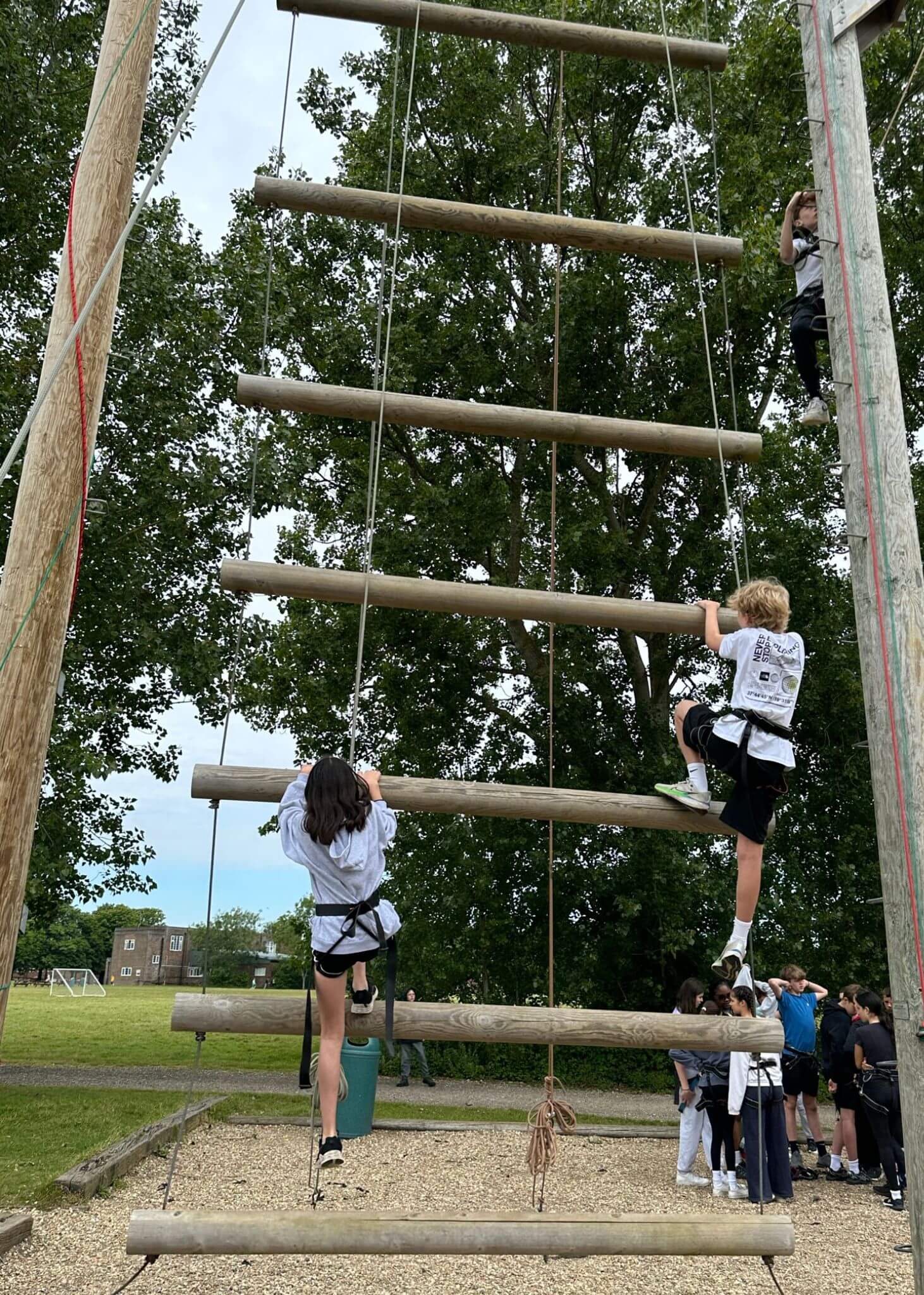 Prep 6 residential trip to the Isle of Wight, pupils climbing a stick wall | Ibstock Place School, Roehampton, Private School Near Richmond, Barnes, Putney, Kingston, & Wandsworth 