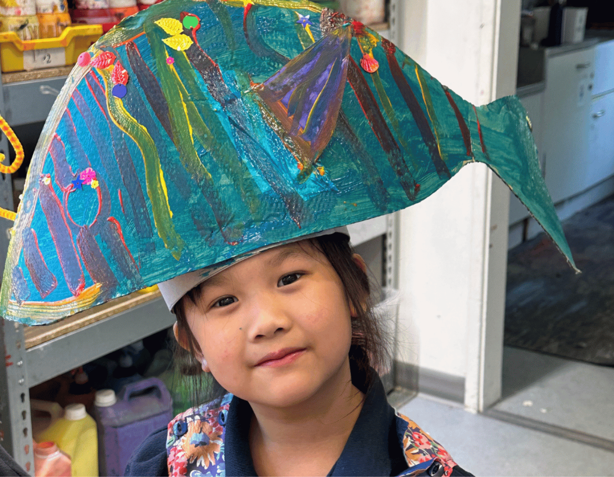 Prep pupil with a paper fish headgear at Ibstock Place School, a private school near Richmond.