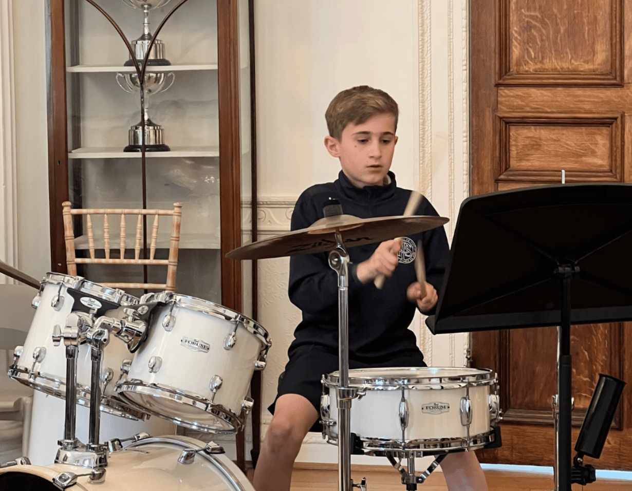 Prep pupil performing a musical instrument at Ibstock Place School, a private school near Richmond.