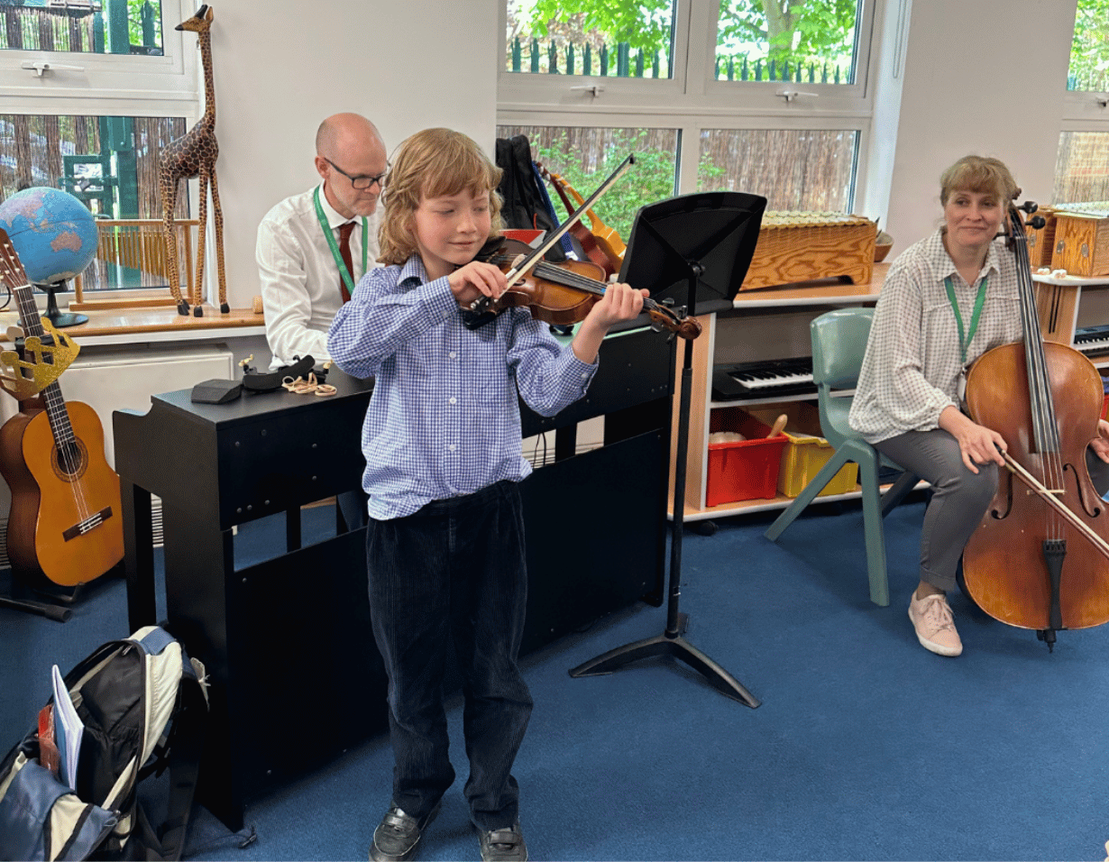 Prep pupil performing a musical instrument at Ibstock Place School, a private school near Richmond.