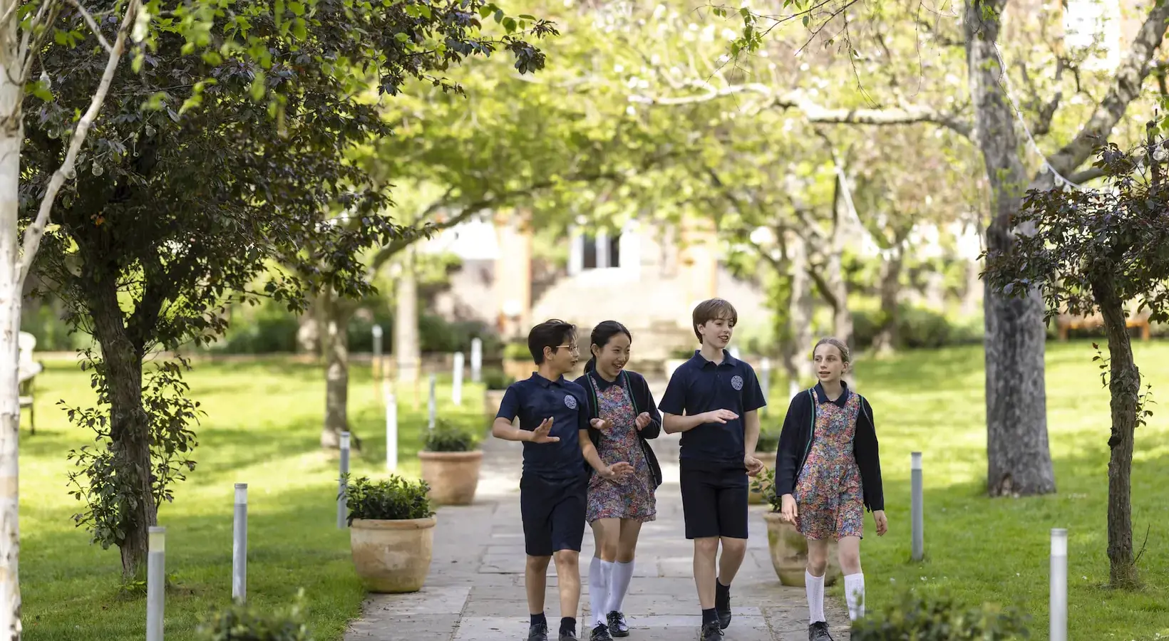 Prep School pupils walking in the grounds at Ibstock Place School, a private school near Richmond, Barnes, Putney, Kingston, & Wandsworth