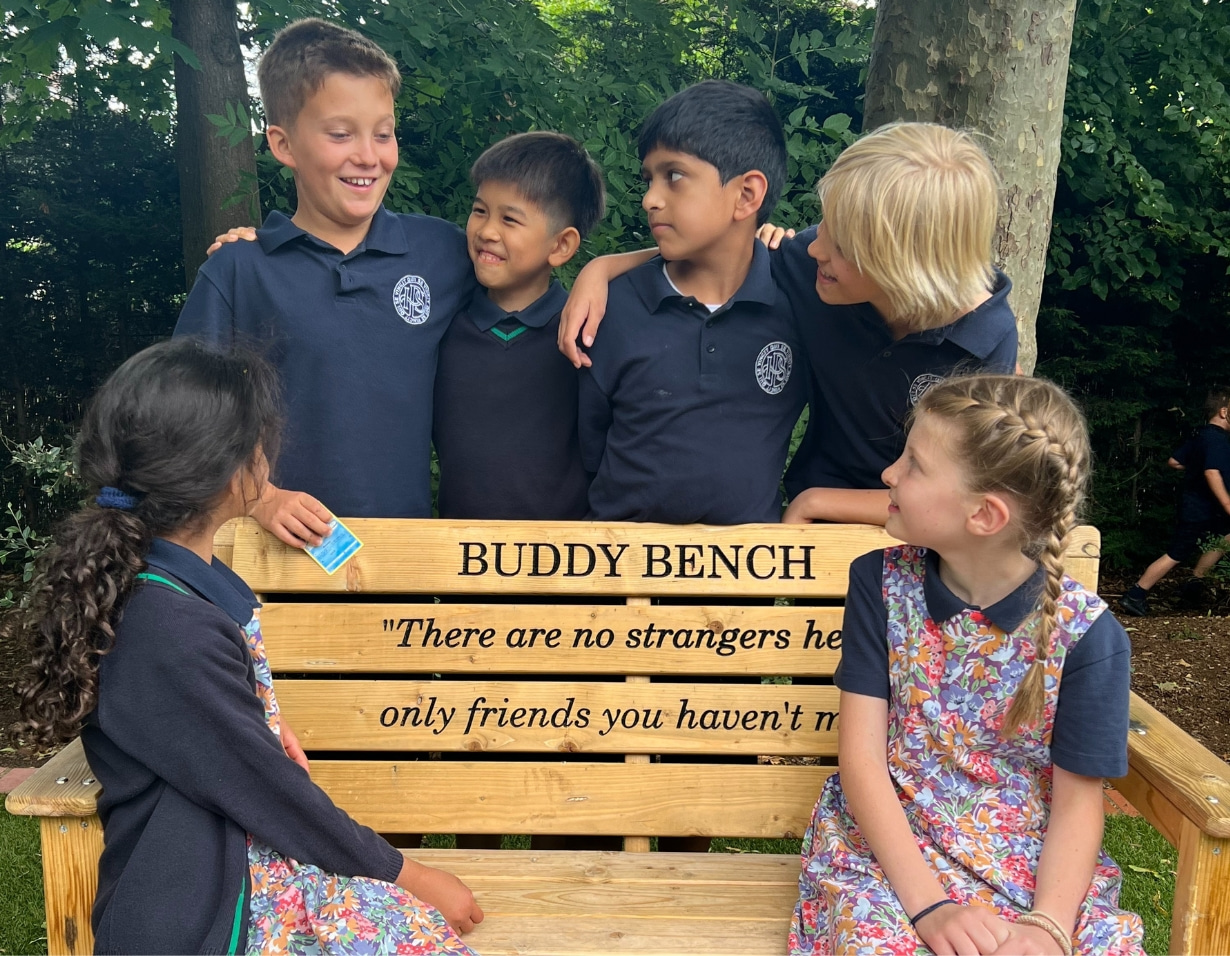 Prep pupils sitting at the buddy bench of Ibstock Place School, a private school near Richmond