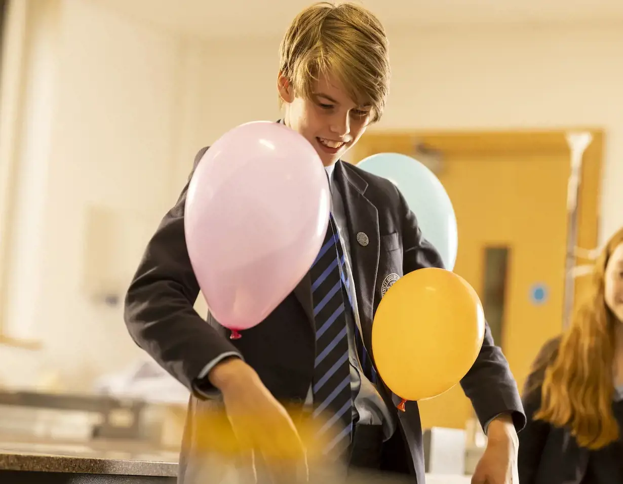 Senior pupils doing a science experiment with balloons at Ibstock Place School, a private school near Richmond, Barnes, Putney, Kingston, and Wandsworth