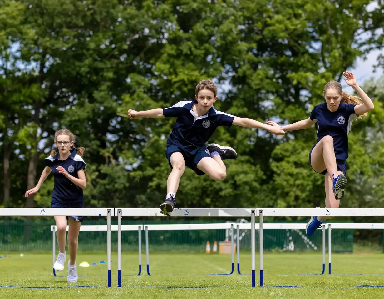 Senior pupils doing a hurdle race at Ibstock Place School, a private school near Richmond, Barnes, Putney, Kingston, and Wandsworth.