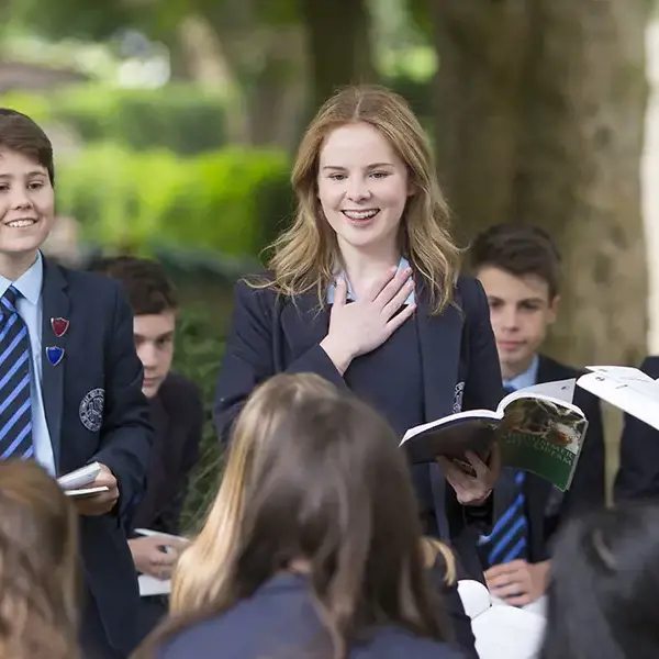 Senior pupils studying outside in groups at Ibstock Place School.