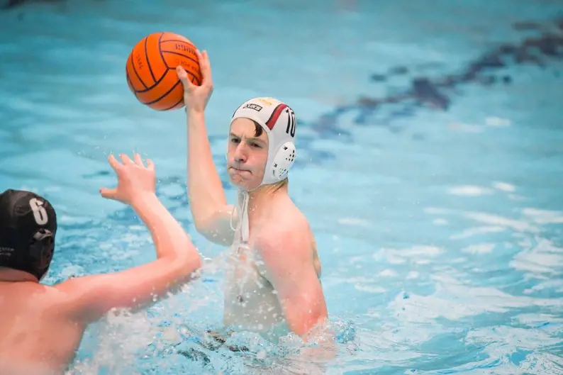 Sixth form pupil playing waterpolo at Ibstock Place School, a private school near Richmond, Barnes, Putney, Kingston, and Wandsworth
