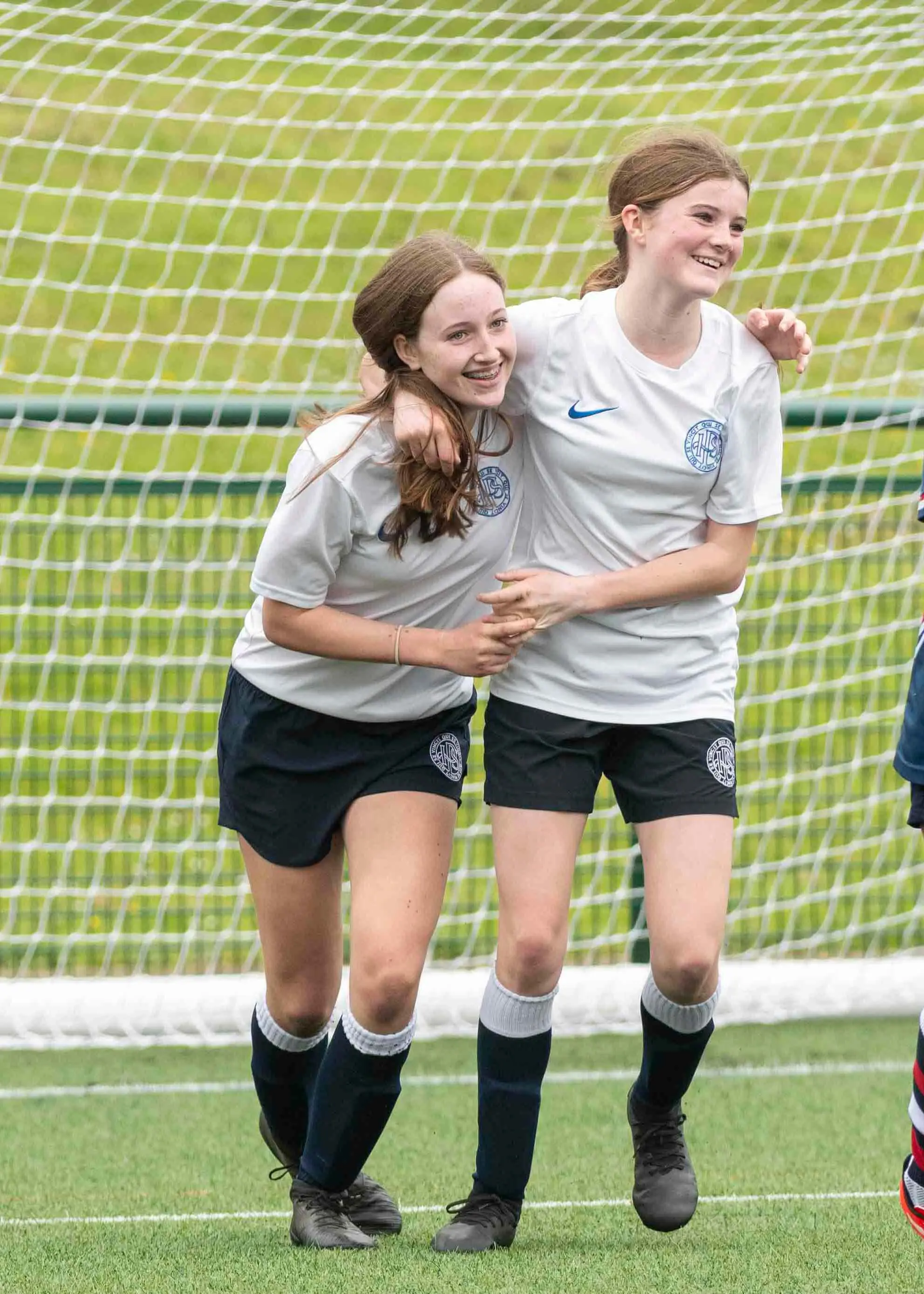 Girls celebrating their goal| Ibstock Place School, a private school near Richmond, Barnes, Putney, Kingston, and Wandsworth.