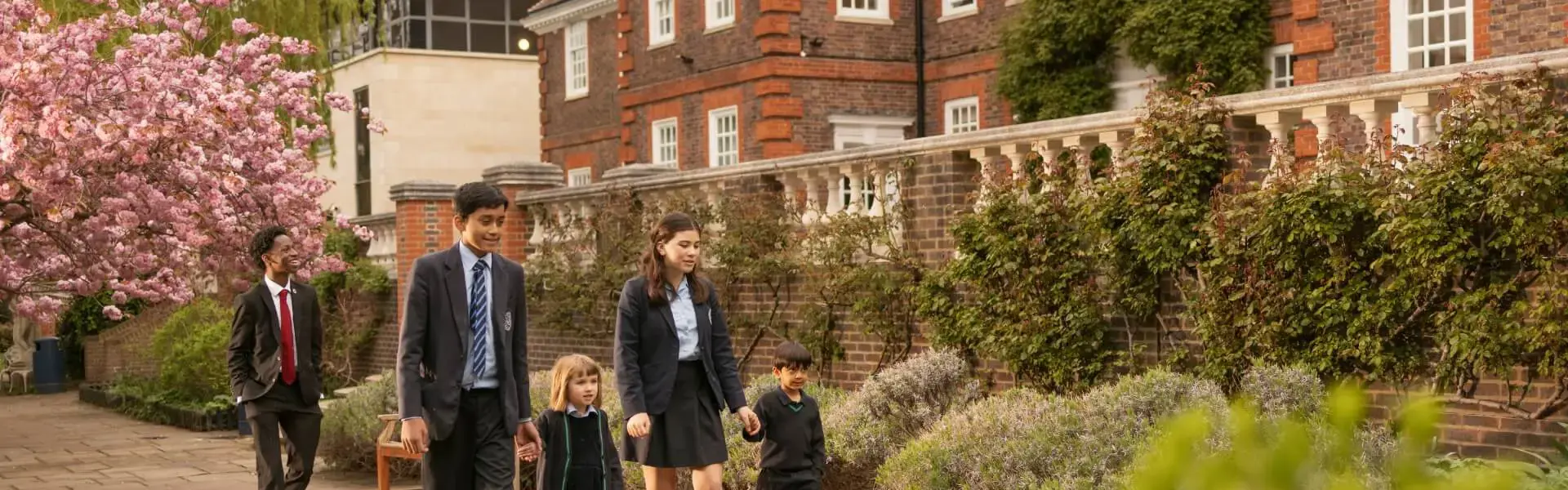 Senior and prep pupils walking together at the campus of  Ibstock Place School, a private school near Richmond.