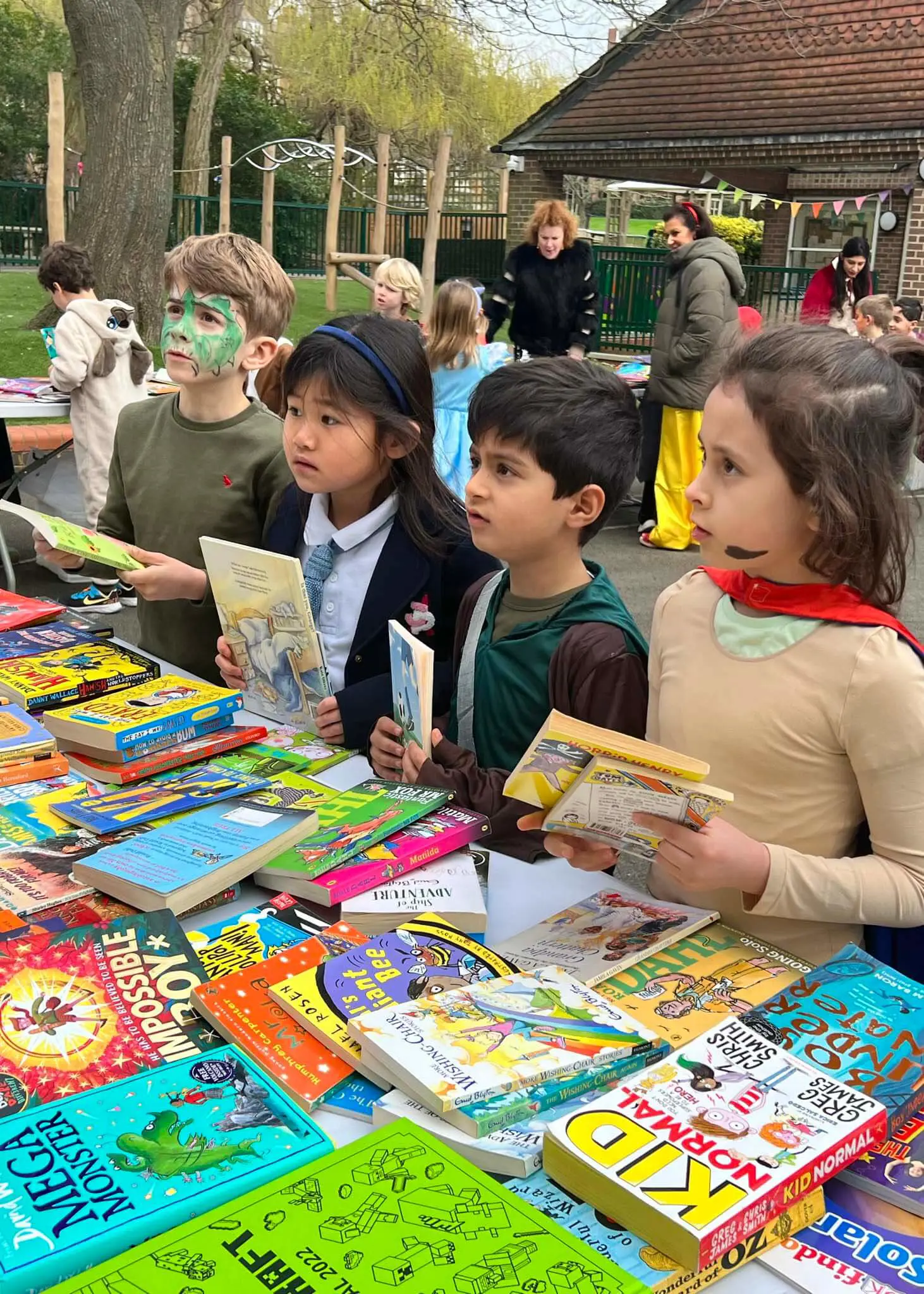 Pupils buying books at the school book sale for  world book day at Ibstock Place School, Roehampton, a private school near Richmond, Barnes, Putney, Kingston, & Wandsworth