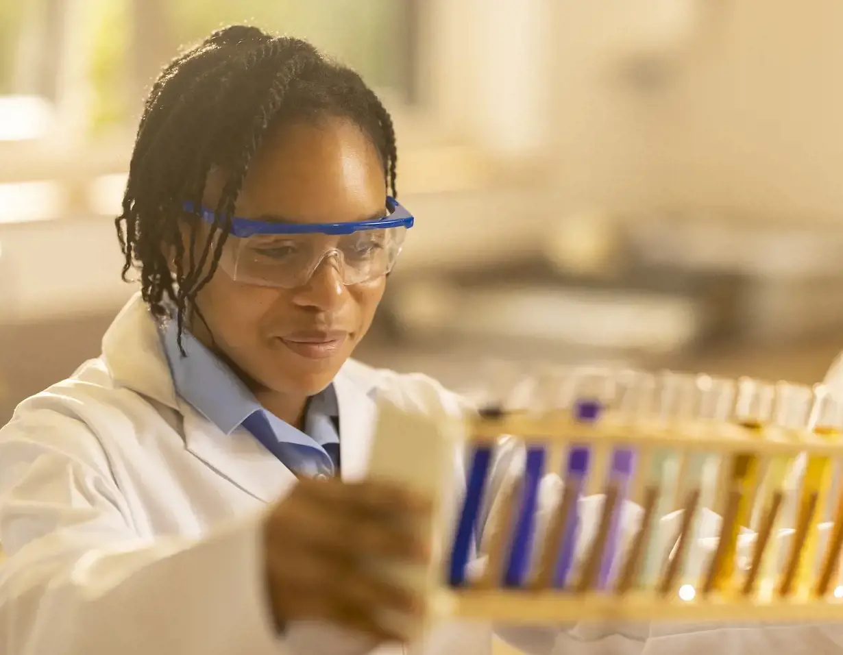 Senior pupil wearing lab safety gear in doing experiment at Ibstock Place School, a private school near Richmond.