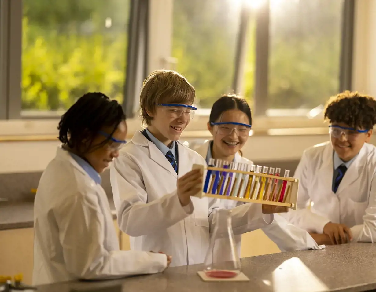 Senior pupils wearing lab safety gear in doing experiment at Ibstock Place School, a private school near Richmond.