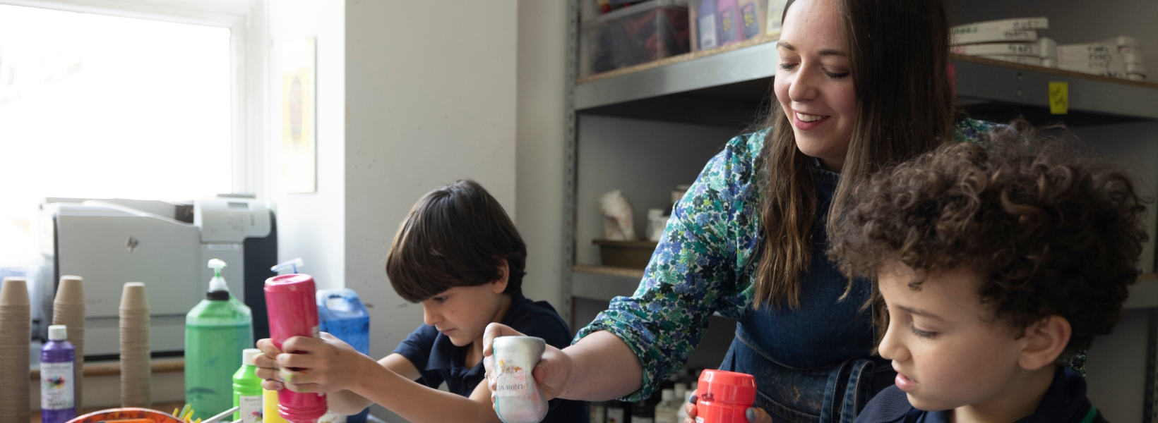 Pre-prep pupils doing art with their art teacher at Ibstock Place School, a private school near Richmond