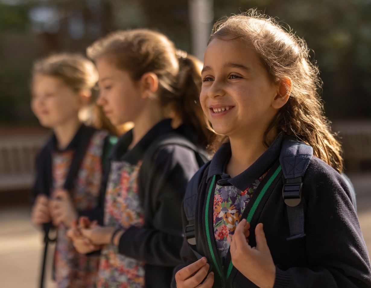 prep pupils wearing their backpacks and entering IbstockPlace School.