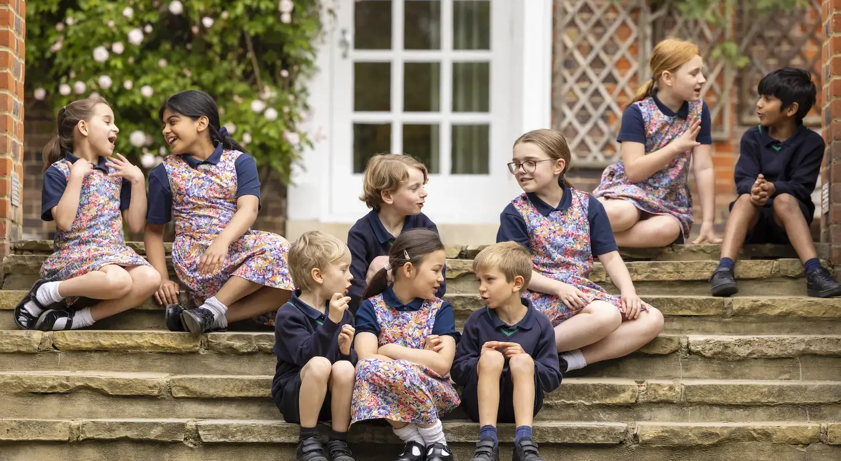 Prep pupils sitting on the stairs of Ibstock Place School, a private school near Richmond, Barnes, Wandsworth.