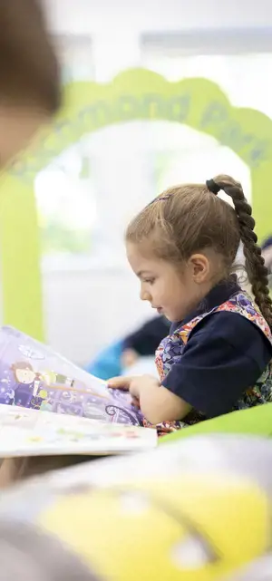 Prep pupils reading in the library of  Ibstock Place School, a private school near Richmond, Barnes, Wandsworth.