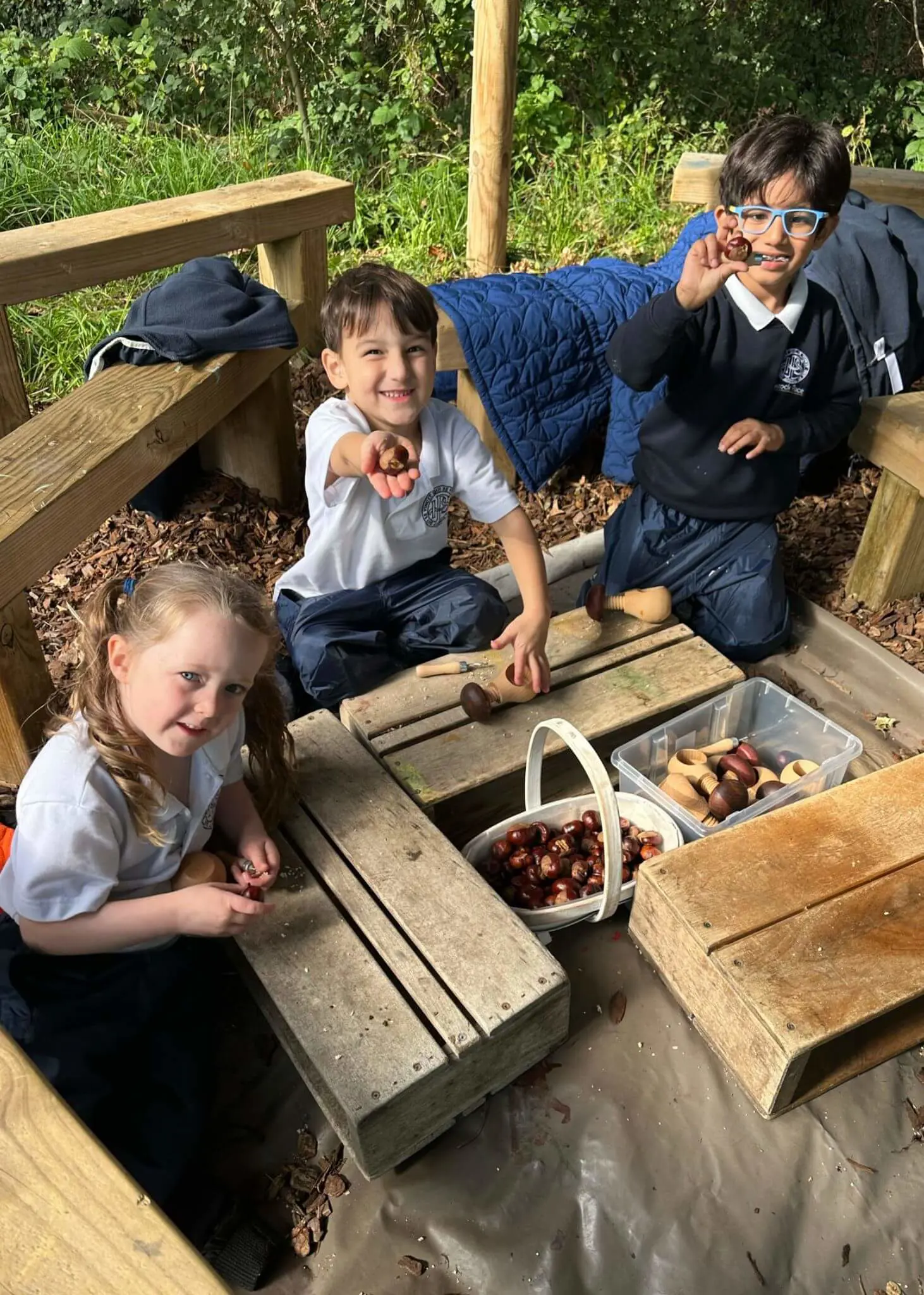 Pre-prep pupils playing with conkers, Ibstock Place School a private school near Richmond, Barnes, Putney, Kingston, and Wandsworth.