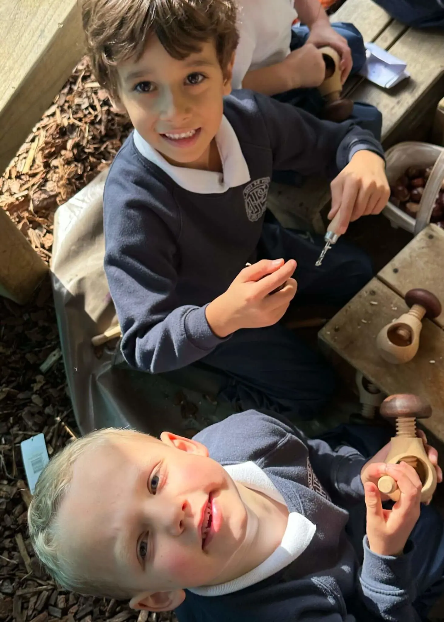 Pre-prep pupils playing with conkers, Ibstock Place School a private school near Richmond, Barnes, Putney, Kingston, and Wandsworth.