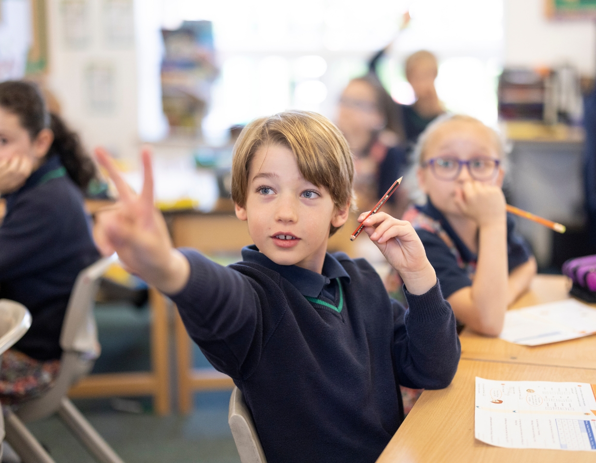 Prep pupil is answering in the class at Ibstock Place School, a private school near Richmond.