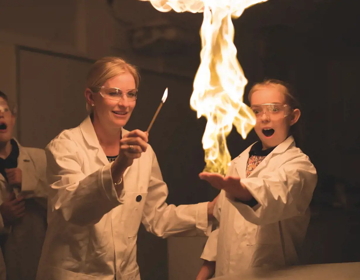 Prep pupils doing an experiment with science teacher at Ibstock Place School, a private school near Richmond, Barnes, Putney, Kingston, & Wandsworth