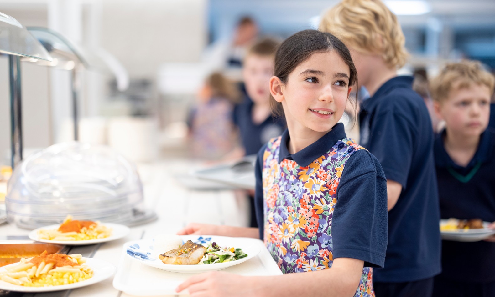 Prep pupil getting lunch at Ibstock Place School, a private school near Richmond, Barnes, Putney, Kingston, & Wandsworth