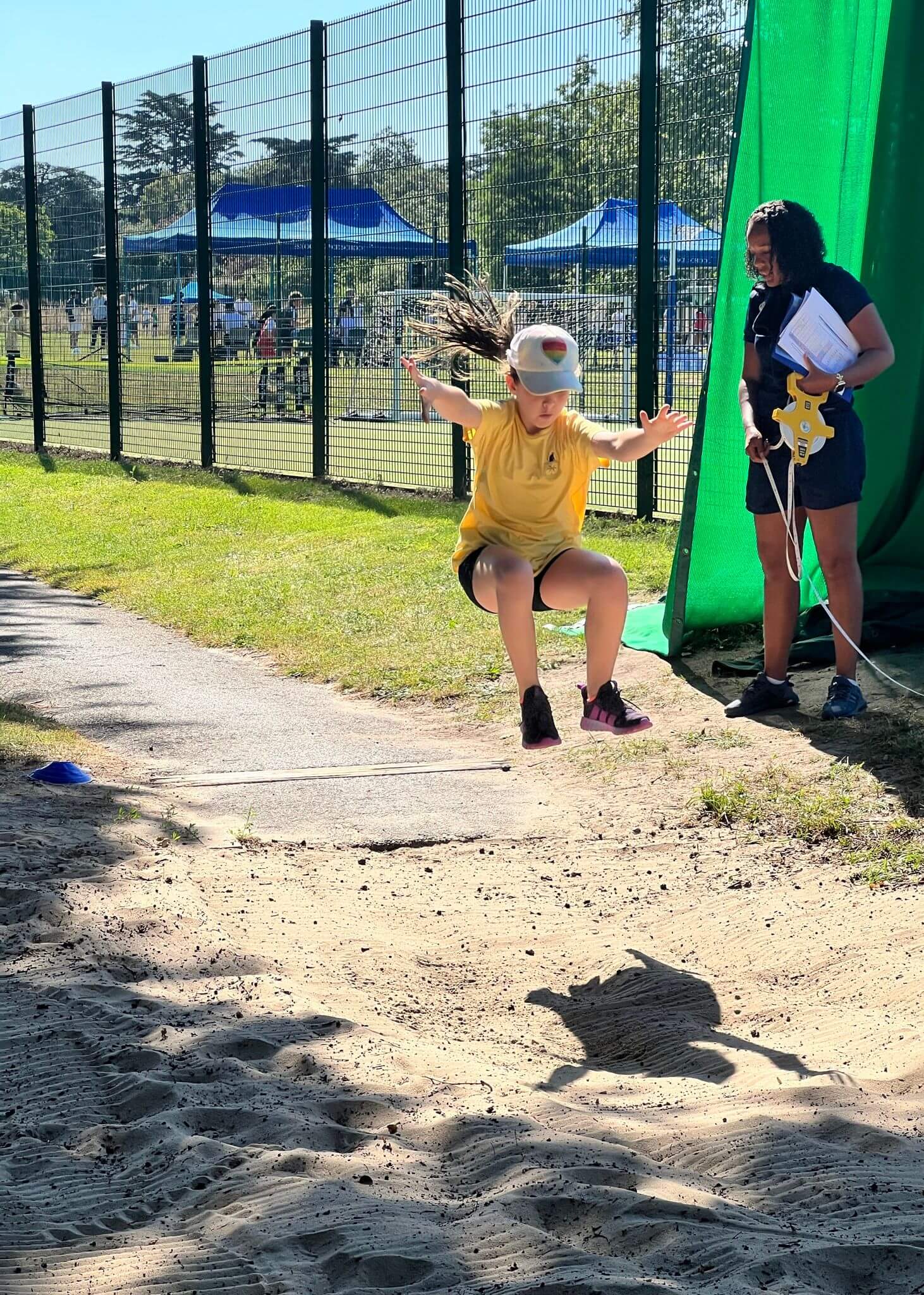 Prep pupil doing a long jump | Ibstock Place School, Roehampton, Private School Near Richmond, Barnes, Putney, Kingston, & Wandsworth 