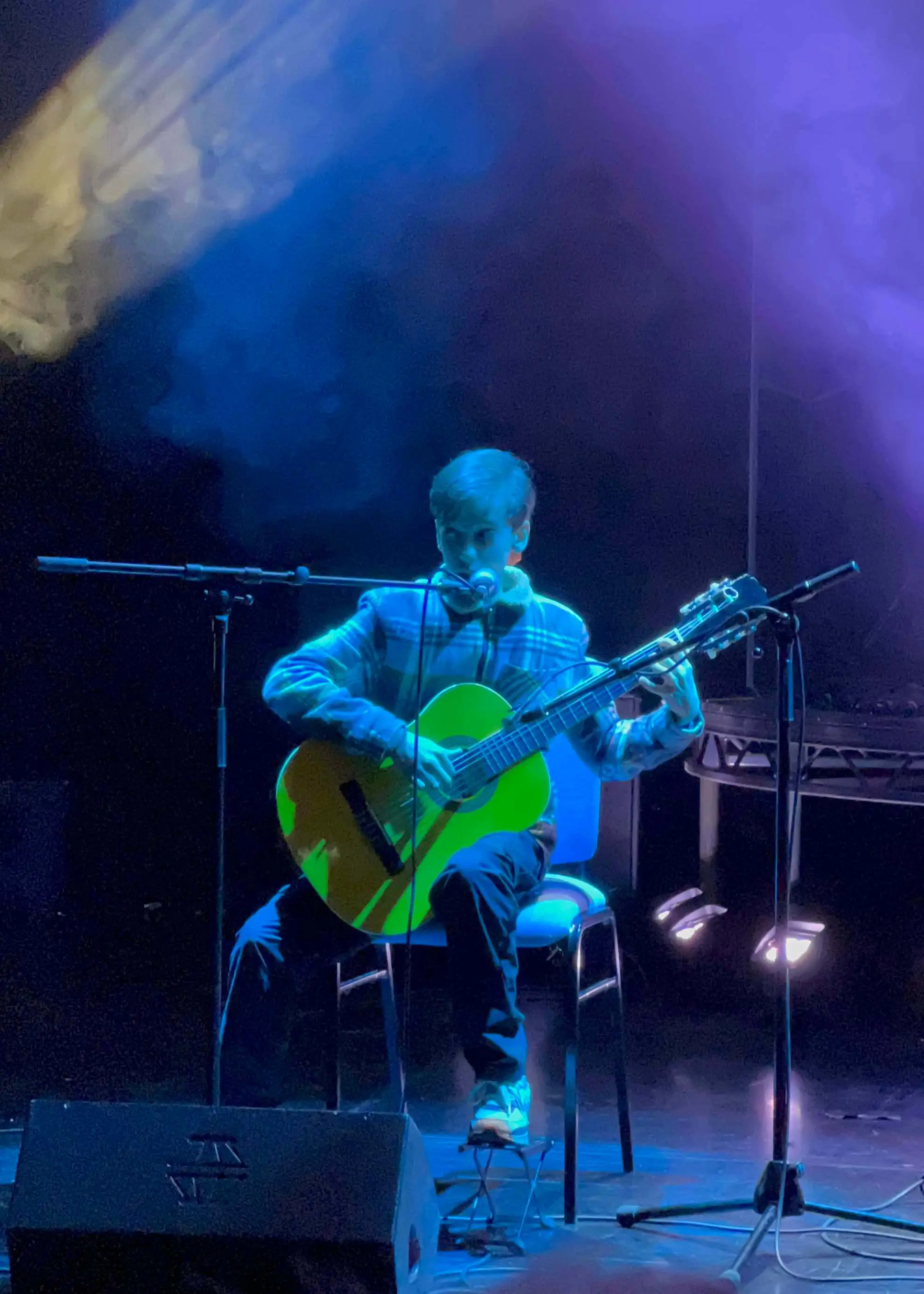 Pupil singing and playing the guitar at Ibstock Place School, Roehampton, a private school near Richmond, Barnes, Putney, Kingston, & Wandsworth