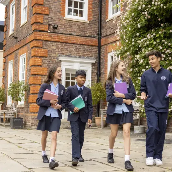 Senior pupils going to their class with books in their hands at Ibstock Place School, a private school near Richmond.