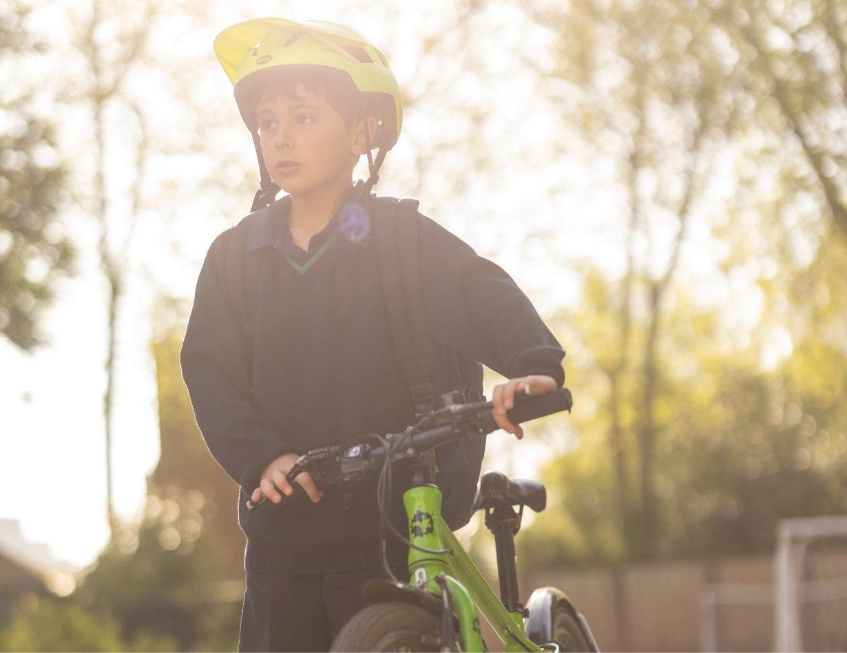 Prep Pupil arriving to Ibstock Place school on cycle.