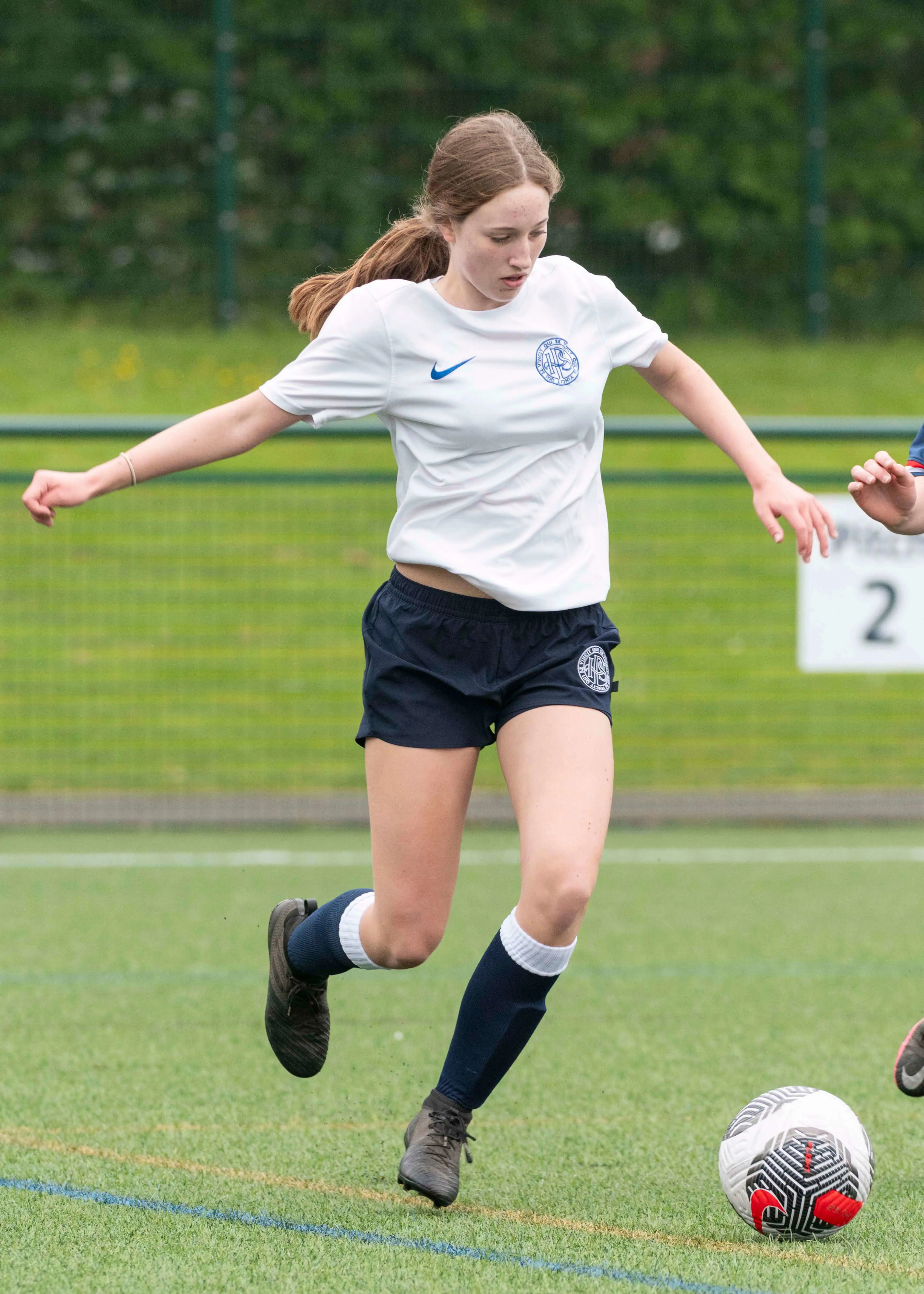 A girl playing football | Ibstock Place School, a private school near Richmond, Barnes, Putney, Kingston, and Wandsworth.