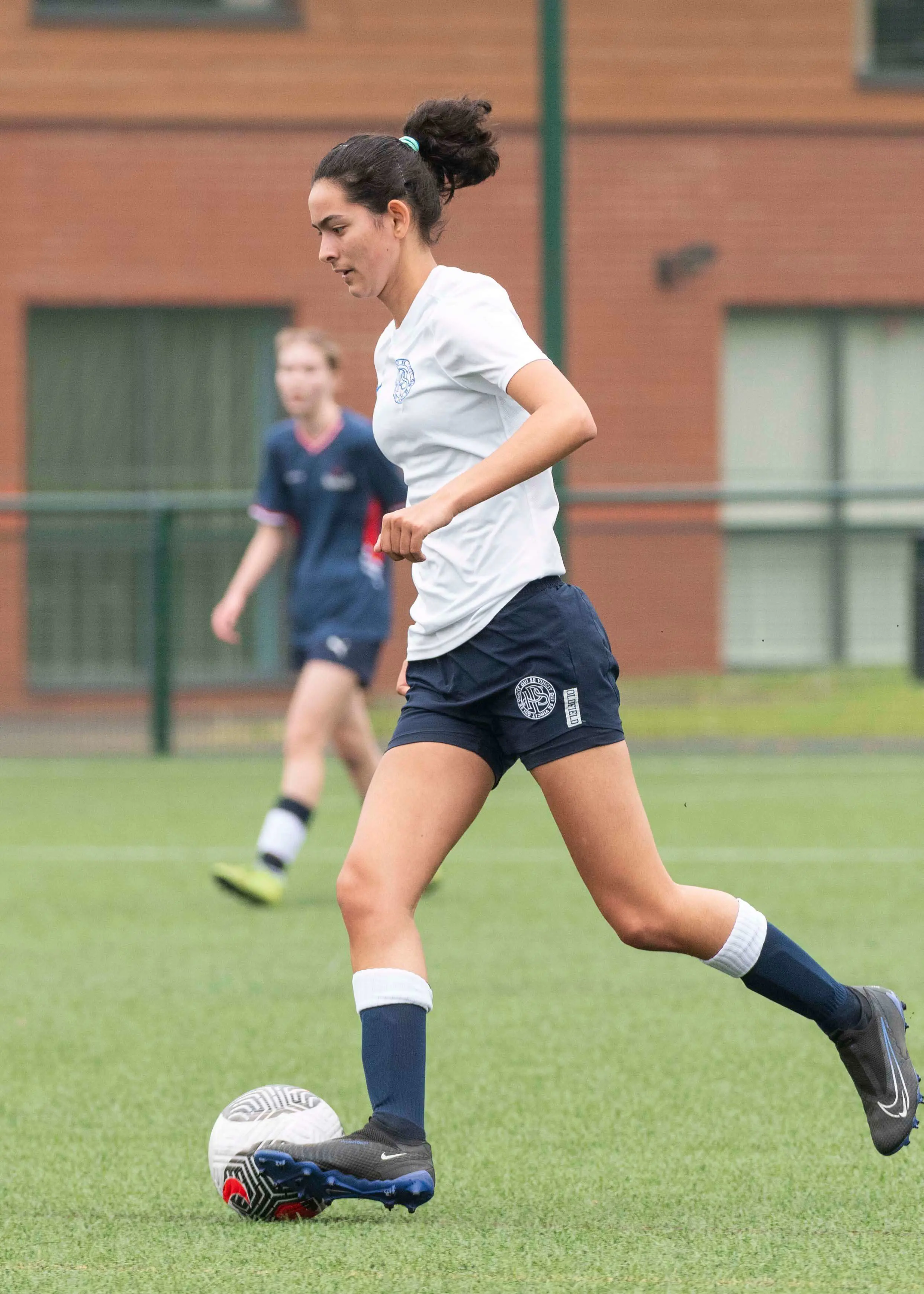 A girl playing football | Ibstock Place School, a private school near Richmond, Barnes, Putney, Kingston, and Wandsworth.