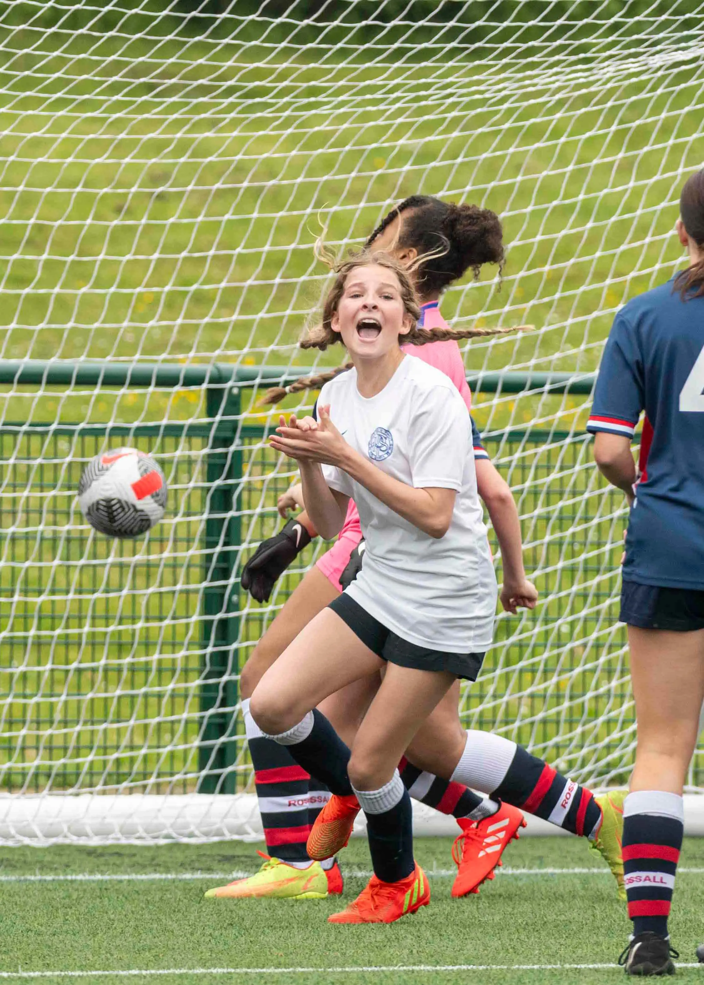 A girl playing football and celebrating her goal| Ibstock Place School, a private school near Richmond, Barnes, Putney, Kingston, and Wandsworth.